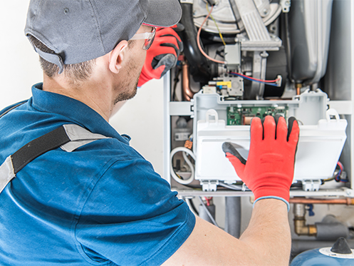 technician repairing a furnace