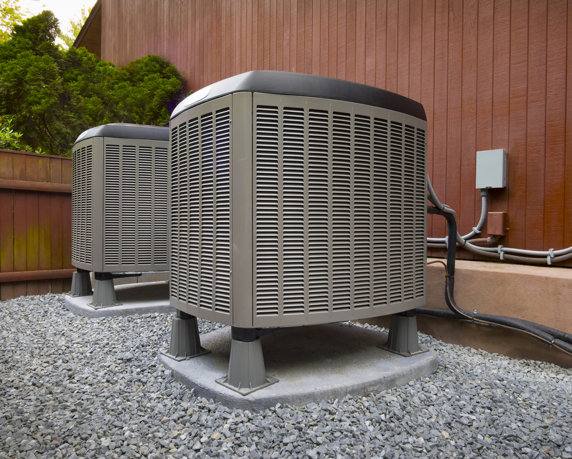 Two HVAC units outside of a home