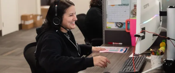 Image of office answering phone urgently to help