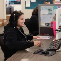 Image of office answering phone urgently to help