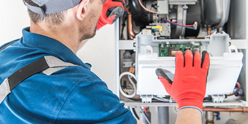 technician repairing a furnace