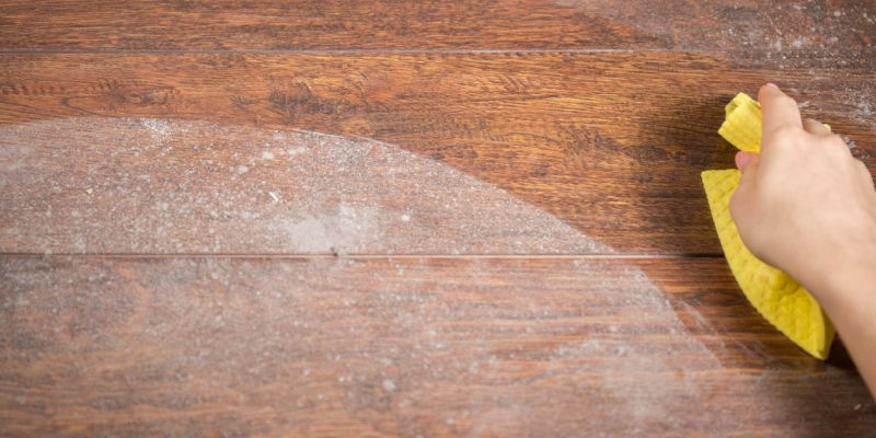 Wiping dusty wood using yellow rag